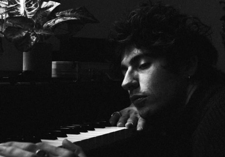 Mattias at the piano in a black and white studio photograph